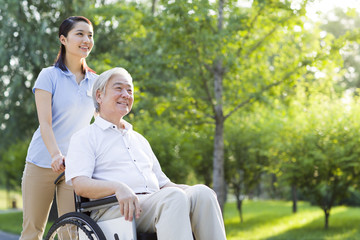 Wheelchair bound man with nursing assistant
