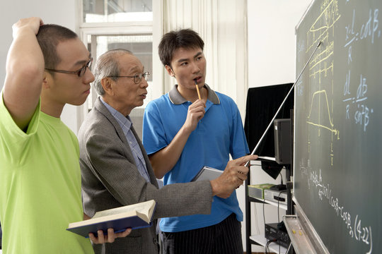 Teacher Lecturing Students In A Class Room