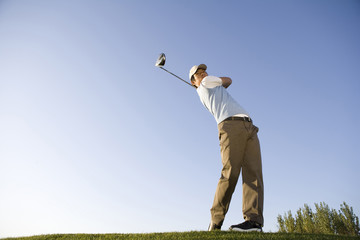 Golfer teeing off on the course