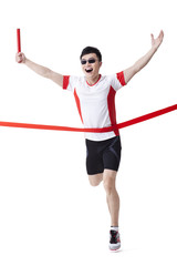 Male athlete with relay baton reaching the finish line