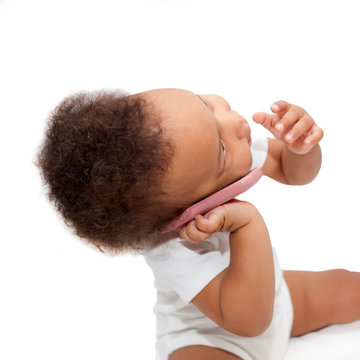 Black Baby Talking And Playing With Mobile Phone.