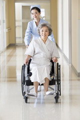 Nurse taking care of senior woman in wheel chair