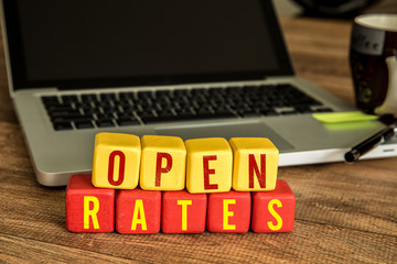 Open Rates written on a wooden cube in a office desk