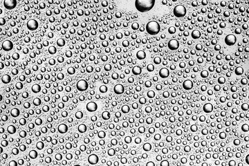 Water drops on transparent glass background.