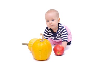 Fototapeta na wymiar child on a white background with pumpkins and apples/charming child with pumpkins and apples; Isolated over White Background