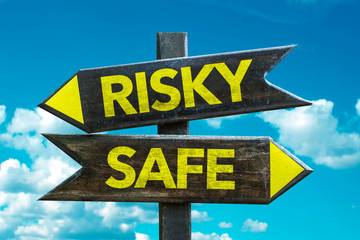 Risky - Safe signpost with sky background