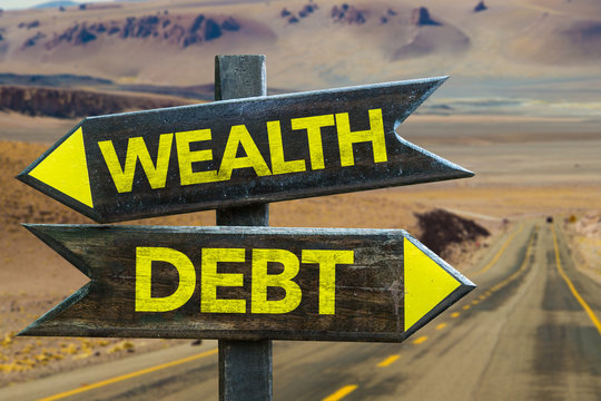 Wealth - Debt signpost in a desert background