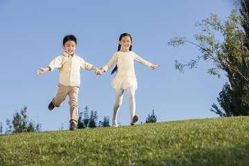 Cute little girl and boy to be flying in a park