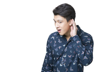 Young man cupping ear to listen