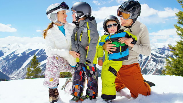 young parents sons outdoor snow ski resort recreation active teamwork park