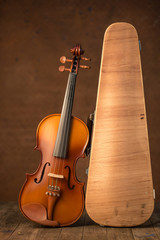 Fototapeta na wymiar Vintage violin and case with old steel background
