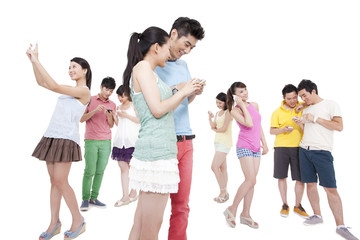 Obraz premium Happy young people and mobile phones