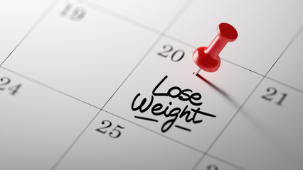 Concept image of a Calendar with a red push pin. Closeup shot of