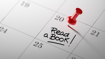 Concept image of a Calendar with a red push pin. Closeup shot of