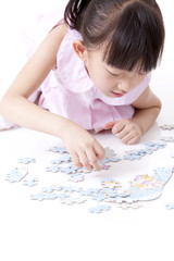 Girl playing jigsaw puzzles