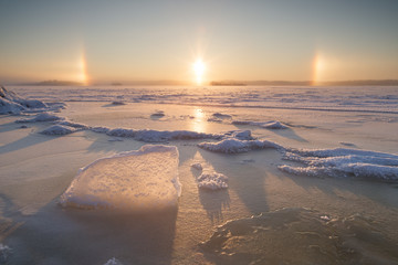 Ice, frozen and snowy lake and halo in Tampere, Finland, in the winter.