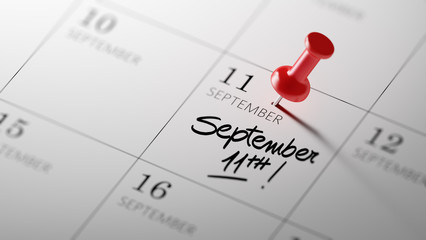 Concept image of a Calendar with a red push pin. Closeup shot of