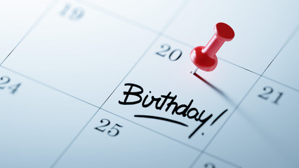 Concept image of a Calendar with a red push pin. Closeup shot of