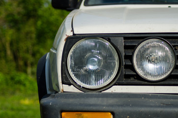 Old white car front lights