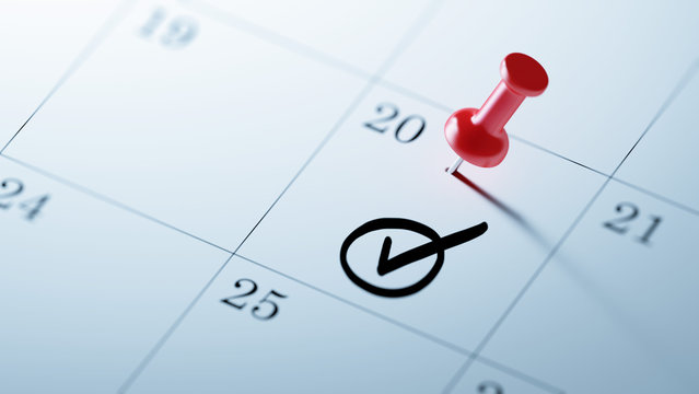 Concept image of a Calendar with a red push pin. Closeup shot of