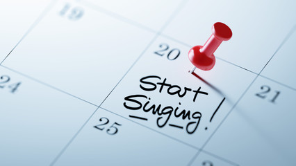 Concept image of a Calendar with a red push pin. Closeup shot of