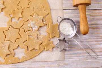 Cutting gingerbread cookies and tools. Process of baking gingerbread cookies at home. Top view.