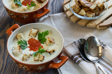 cheese soup puree with croutons and red caviar