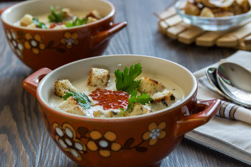 cheese soup puree with croutons and red caviar