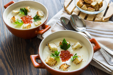 cheese soup puree with croutons and red caviar