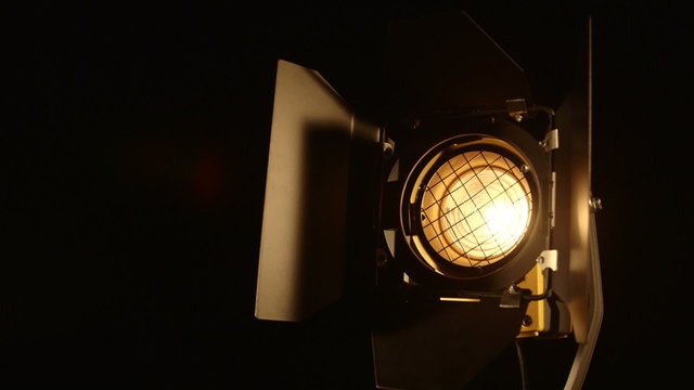 Slowly dimming video studio fresnel lens spot light turn on and off