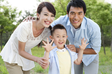 Portrait of young family on grass