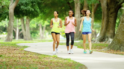 Young happy multi ethnic American girls power walking to keep healthy