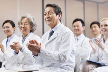 Medical workers clapping in a meeting