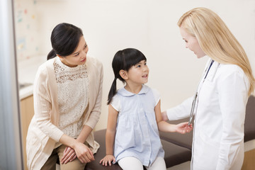 Doctor talking with little girl
