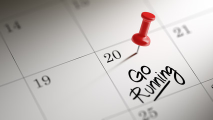 Concept image of a Calendar with a red push pin. Closeup shot of