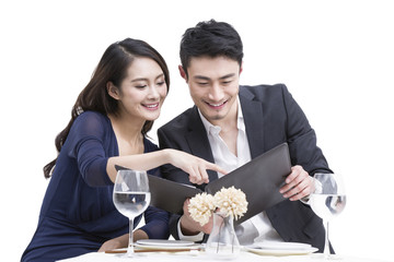 Young couple reading menu in restaurant