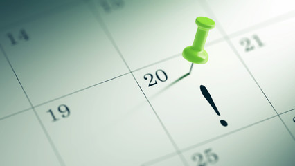 Concept image of a Calendar with a green push pin. Closeup shot