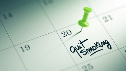 Concept image of a Calendar with a green push pin. Closeup shot