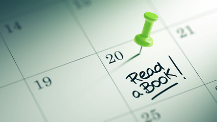 Concept image of a Calendar with a green push pin. Closeup shot