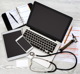 Wood doctor's desk in high definition with laptop, tablet and mo