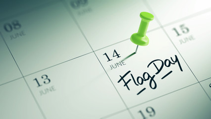 Concept image of a Calendar with a green push pin. Closeup shot