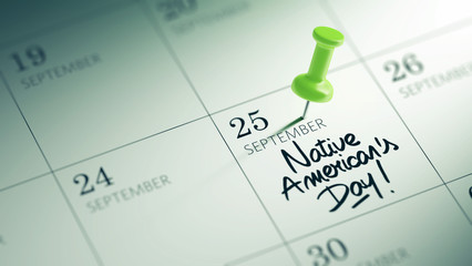 Fototapeta premium Concept image of a Calendar with a green push pin. Closeup shot