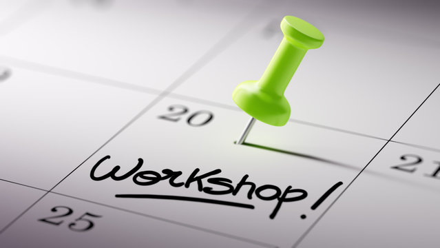 Concept image of a Calendar with a green push pin. Closeup shot