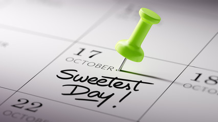 Concept image of a Calendar with a green push pin. Closeup shot