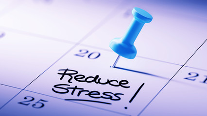 Concept image of a Calendar with a blue push pin. Closeup shot o
