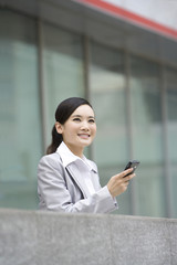 Fototapeta na wymiar Businesswoman using cellphone