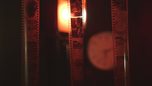 Black and white film processing negatives drying in photography dark room dolly close-up
