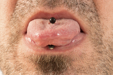 Fototapeta premium Man showing off his tongue ring
