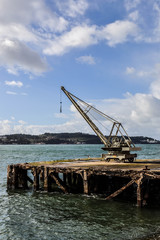 Antique peer with crane from an powerplant on the river