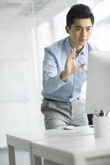 Young businessman using computer in office